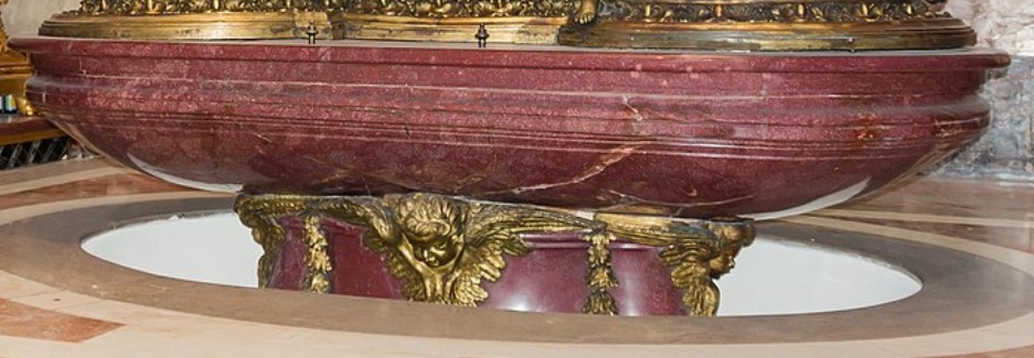 The red porphyry lid of Emperor Hadrian's sarcophagus, transformed into a baptismal font. Now conserved in St. Peter's Basilica, Vatican City.