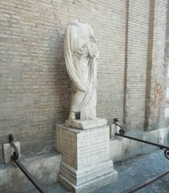 In the narrow Vicolo dell'Abate Luigi (to the left of the Palazzo Vidoni) is a very ancient mutilated statue, called Abate Luigi; the people said it kept up dialogues with Donna Lucrezia, the ancient statue near Saint Marco, similar to those that were supposed to go on between Pasquino and Marforio.